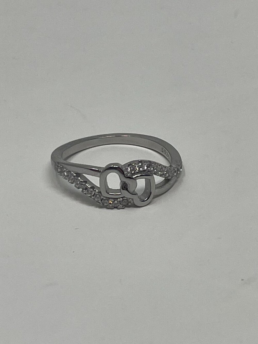 Sterling Silver Featuring Two intertwined hearts with Pave crystals accents